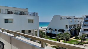 A modern building with balconies overlooking a beach. - Aegean #329 | Community Pool & Tennis + Shuffleboard (Destin)