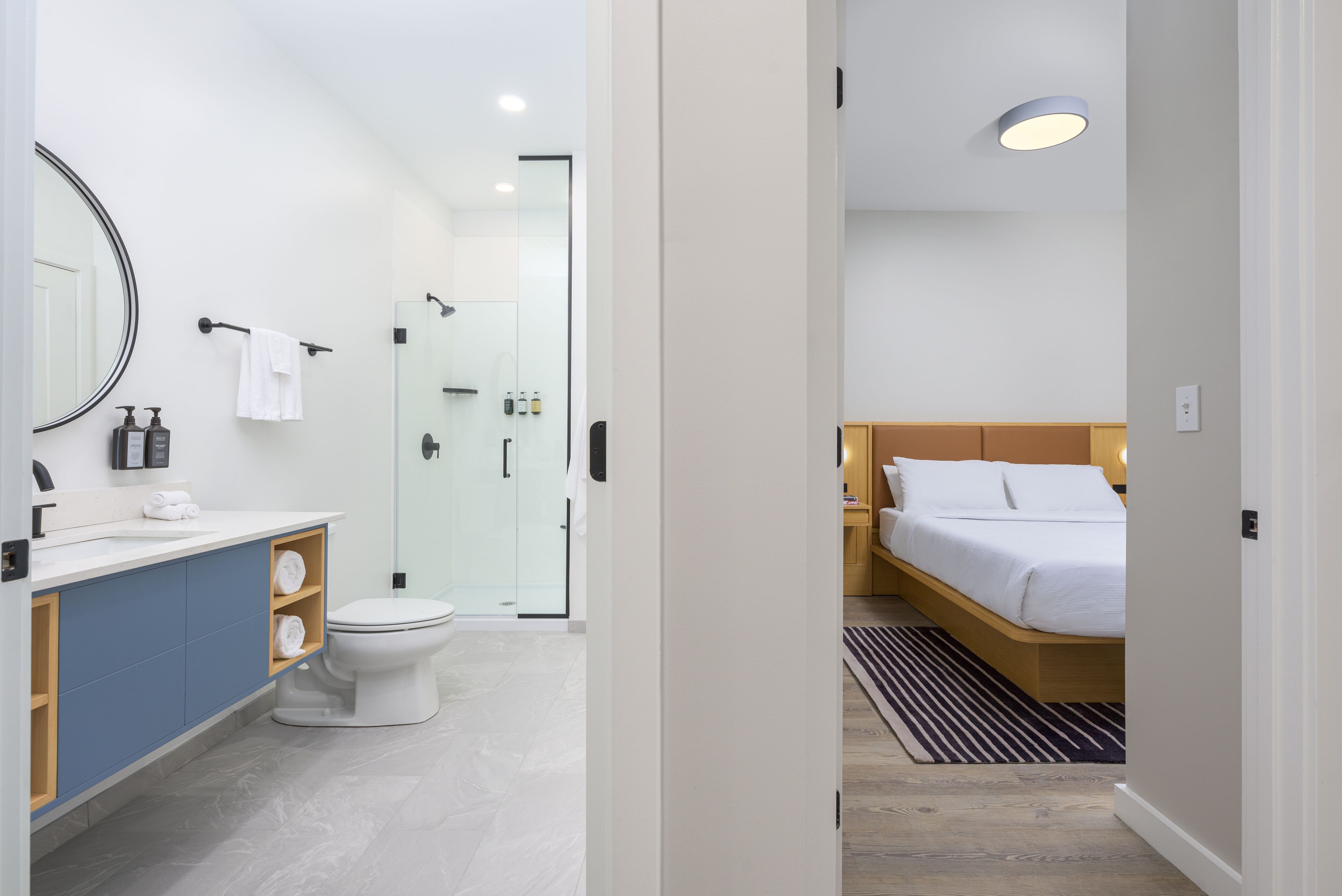 A modern bathroom with a toilet, sink, and shower.