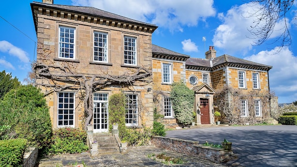 A large stone building with multiple windows and a prominent tree in front. - Pennine Hall Apt (Thirsk)