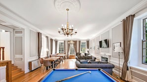 A spacious room with a pool table, a sofa, and a dining area. - Pennine Hall Apt (Thirsk)
