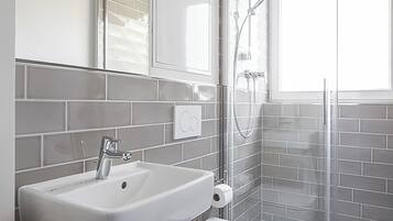 Shower, rainfall showerhead, hair dryer, towels