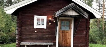 Log cabin. Ramsjö Camping . Ångevägen 24. Timber log nearby river stream