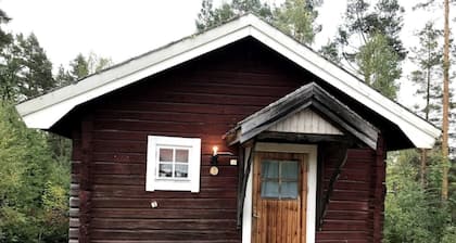Log cabin. Ramsjö Camping . Ångevägen 24. Timber log nearby river stream