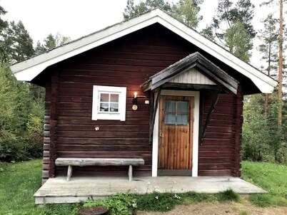 Log cabin. Ramsjö Camping . Ångevägen 24. Timber log nearby river stream