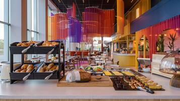 A buffet area with various pastries and fruits.