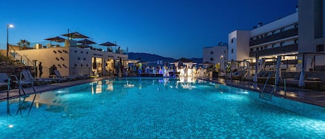 Outdoor pool, a heated pool, open 10:00 AM to 10:00 PM, pool umbrellas