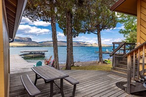 Outdoor dining - Lakefront home with private beach, dock, firepit, & grill - dazzling sunset view (Big Arm)