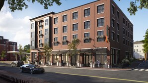 A multi-story brick building with a flat roof, large windows, and outdoor seating areas. - Longfellow Hotel (Portland)