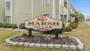 A sign for 'Marsh Villas' with a phone number '4801'.