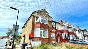 A two-story house with a red brick facade, a satellite dish, and a 'bennett holmes' sign indicating a property for sale. - Lovely 2-bed Tree-hole in Northolt Southharrow (Northolt)