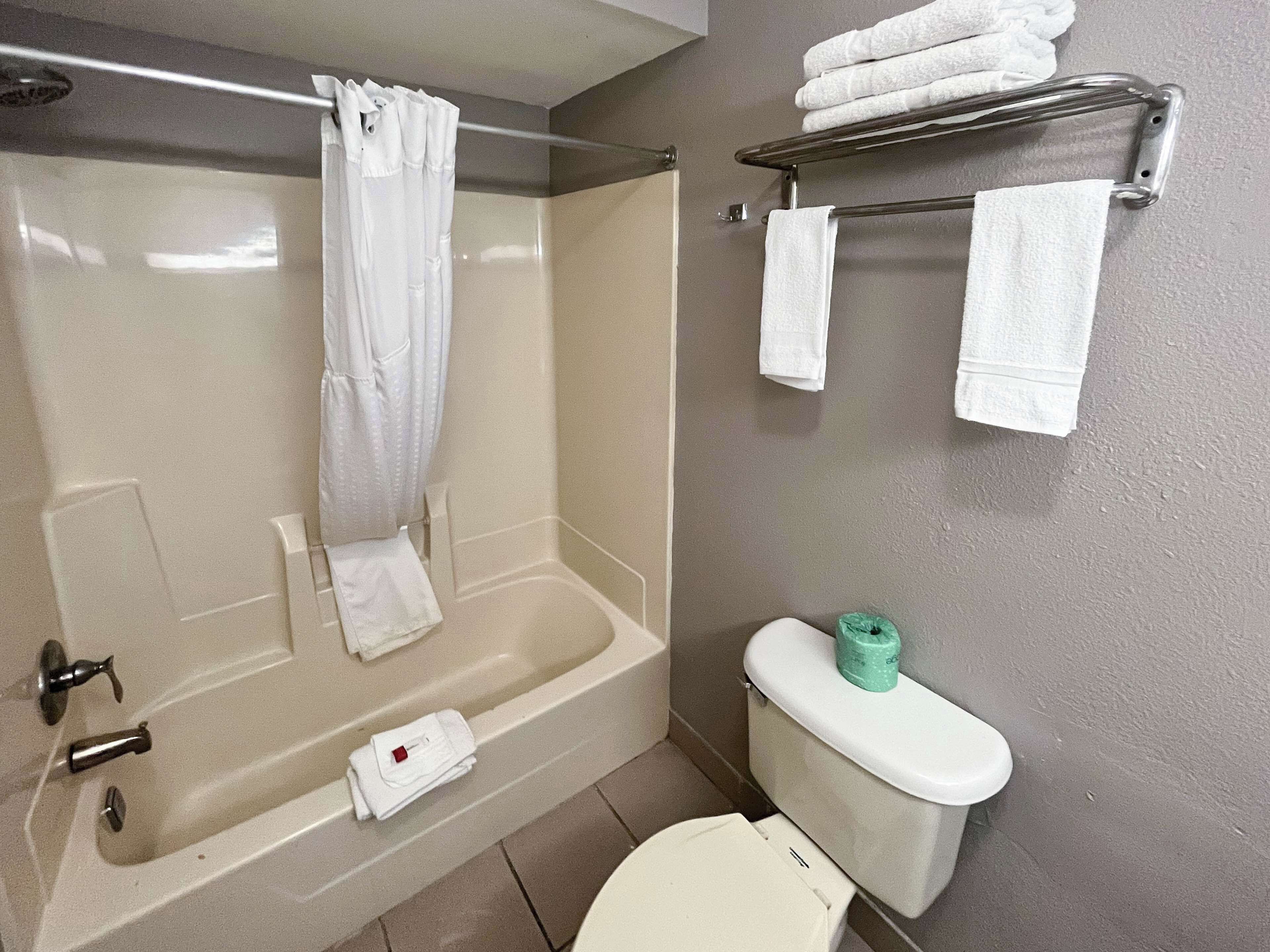 Combined shower/bathtub, towels, soap, toilet paper