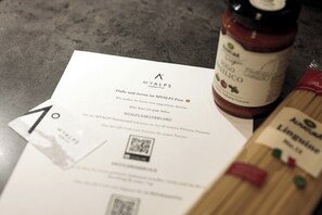 Recibo da MYALPS Pure, uma garrafa de molho de tomate orgânico e um cartão com um código QR.