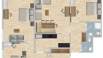 Plano de un cuarto de hotel que incluye una cama, un sofá, una mesa de comedor, una cocina y un baño.