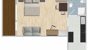 A hotel room layout with a bed, sofa, desk, and kitchenette.