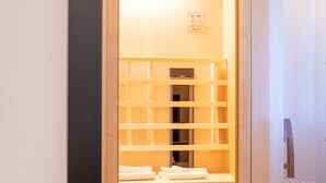 A walk-in closet with a sliding door, a built-in shelf unit, and a chair. - Katzerhaus Ebensee (Ebensee)