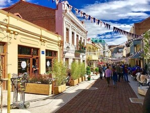 A cobblestone street lined with historic buildings, some with visible storefronts and signage. - Historic Apartments "1868 Tbilisi" Best Location (Tbilisi)