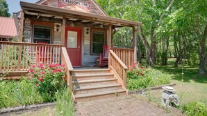 A rustic wooden building with a porch, steps, and a sign that reads "C.E. HESSON'S GRO." - Gorgeous country cottage (Springfield)