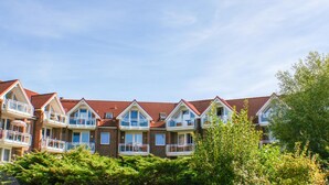 A row of townhouses with red-tiled roofs and multiple balconies. - Beautiful, bright vacation apartment with swimming pool, Residence Kormoran15 (Cuxhaven)