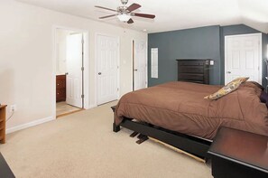 Cozy retreat with a single bed, dresser, and table, perfect for a relaxing stay.