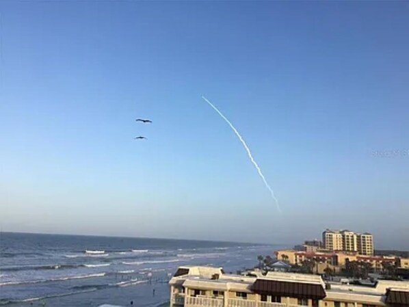 A coastal view with buildings and a clear sky.
