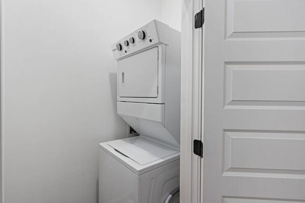 A compact laundry room with a washer and dryer stacked vertically.