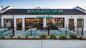 A modern building with a sign reading "Southern Grist Brewing Co." and outdoor seating. - Condo with Free Parking, 3 miles Downtown, near Restaurants (Nashville)