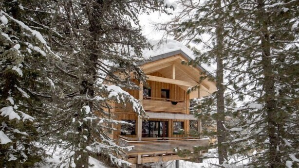 A wooden cabin with a balcony, surrounded by snow-covered trees. - # 25 mit Sauna und Sprudelbad innen by Interhome (Turracher Höhe)