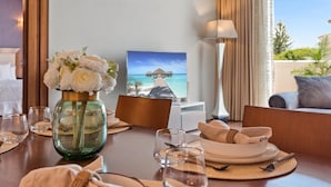 A dining table set with plates, glasses, and a vase of flowers. - Apartment in Playas del Duque for 6 people| Casa Granada 146 (Puerto Banús - Marbella)