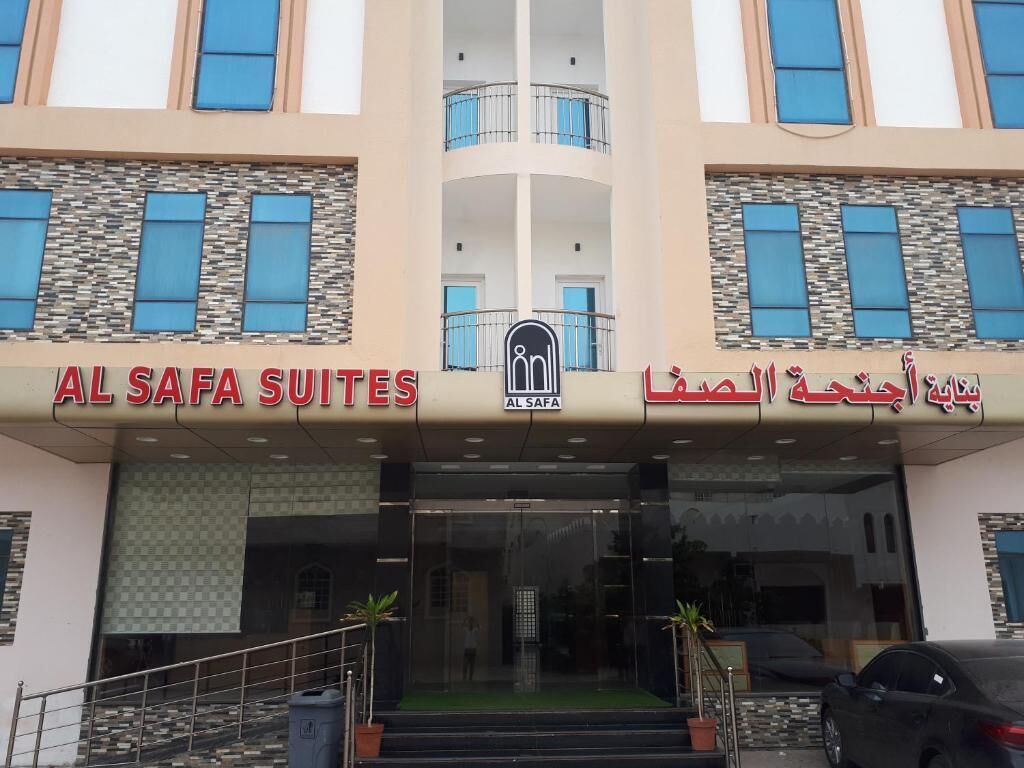 The entrance to Al Safa Suites with a modern design, featuring a central logo and bilingual signage in English and Arabic.