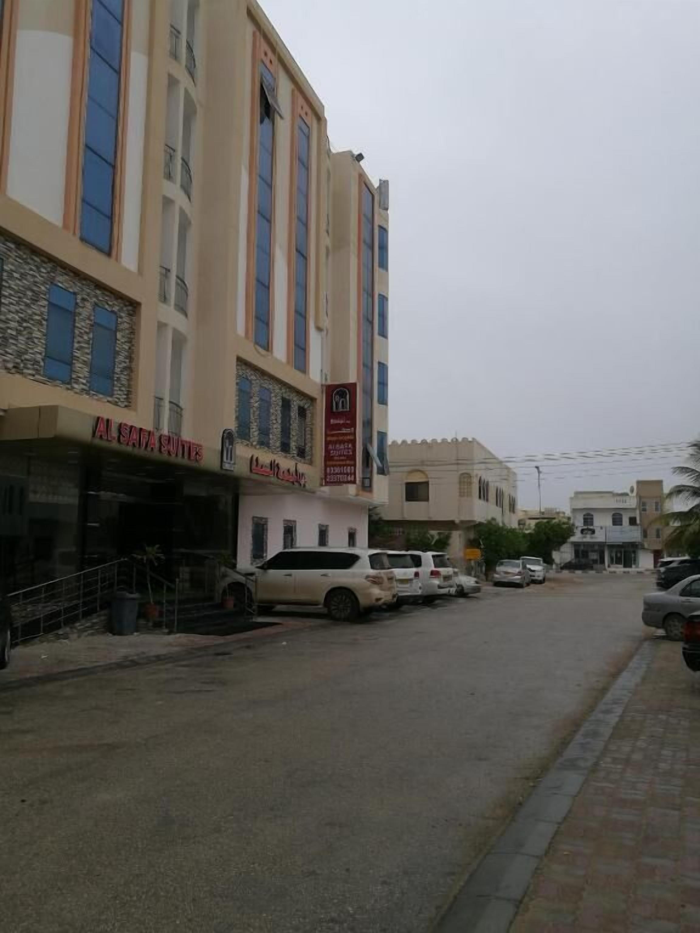 A multi-story building with a sign for 'Al Safa Suites' on the ground floor.