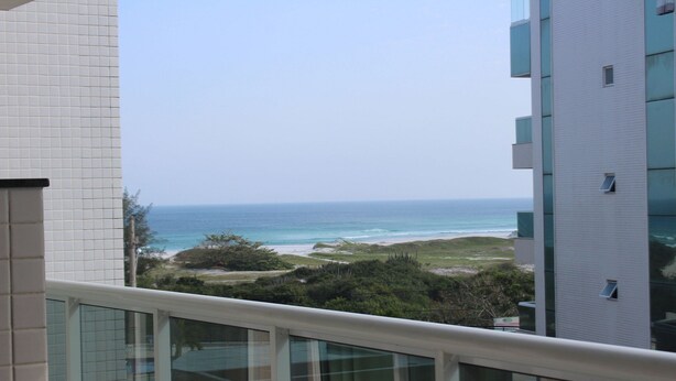 Blick vom Balkon auf einen Strand bei klarem Himmel.