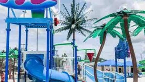 A water park play area with slides and a wave-themed structure. - Newly Updated House on Double Lot (North Port)