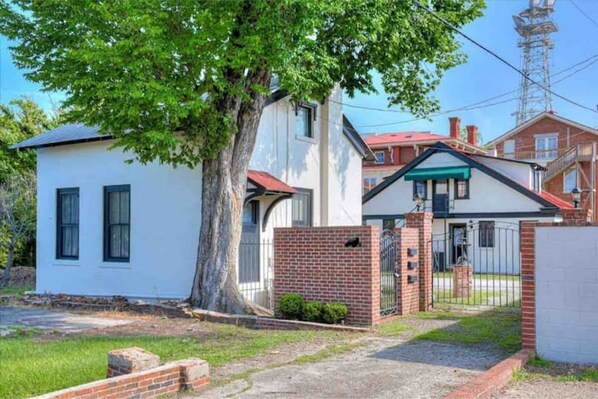 Stroll through the secure, tree-shaded entrance of this two-story home.