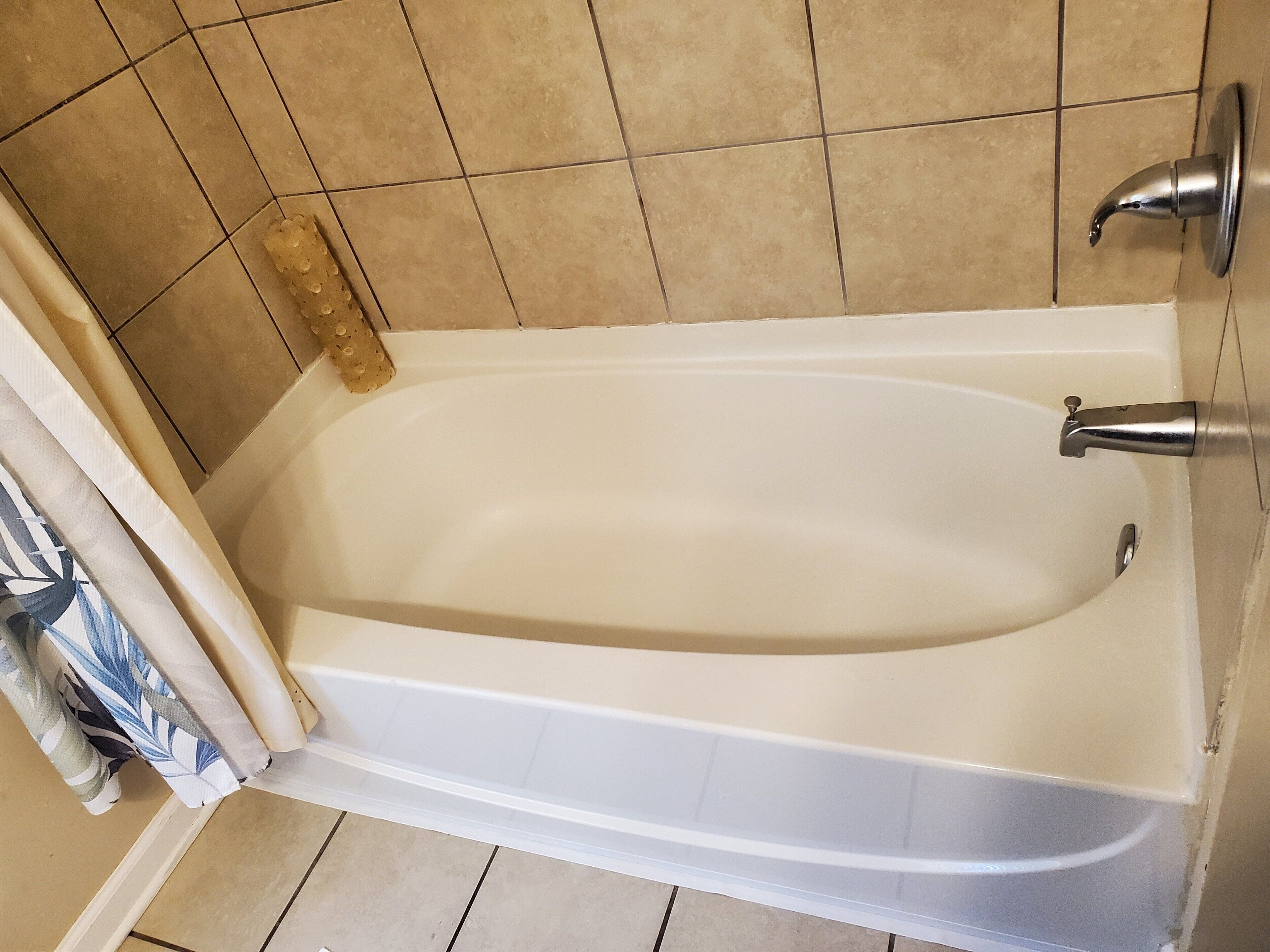 A bathroom with a bathtub, a shower, and a toilet.