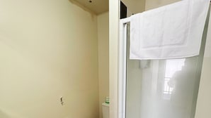 A bathroom with a toilet, sink, and shower.