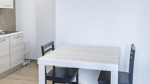 A modern kitchen with a white countertop, a sink, and a small metal rack. - P011 - Porto Recanati, new studio facing the sea (Porto Recanati)
