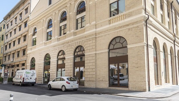 A multi-story building with arched windows and a large entrance. - A31 - Ancona, new studio apartment in the centre (Ancona)