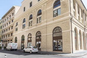 A multi-story building with arched windows and a large entrance. - A31 - Ancona, new studio apartment in the centre (Ancona)