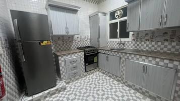 Full-sized fridge, electric kettle, cookware/dishes/utensils