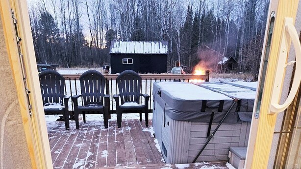 A wooden deck with chairs and a hot tub, surrounded by a wooden fence and trees. - Haywire Haus, Pictured Rocks, Hot Tub, ORV Trail (Shingleton)