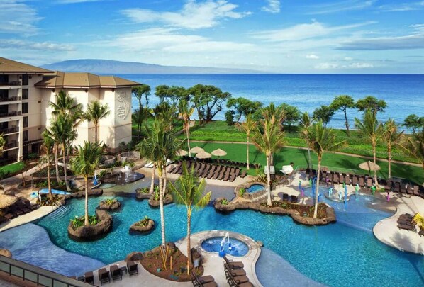 Relax by the pool surrounded by palm trees and take in the breathtaking ocean views.