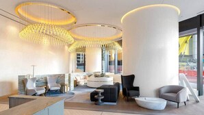 A modern lobby with a reception desk, seating area, and large columns. - CASSA ONE - Luxury Riverside Living in BNE CBD (Brisbane)