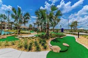 Enjoy a serene golfing experience amidst lush green spaces and palm trees.