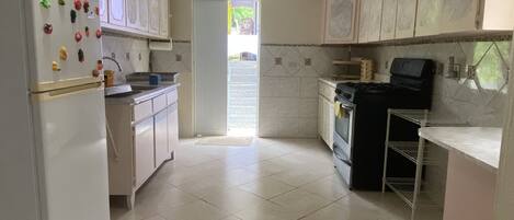 Fridge, coffee/tea maker, cookware/dishes/utensils, dining tables