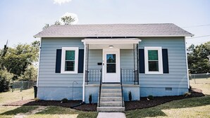 A two-story house with a front porch, a small front yard, and a mailbox. - Walking Distance to Casino (Danvilel)