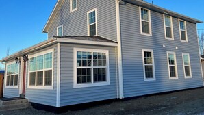 A two-story house with a gable roof, white trim, and multiple windows. - Hyland Hotel (Palmer)