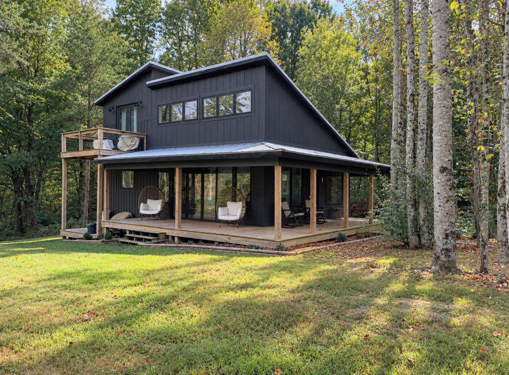 A two-story house with a covered porch and outdoor seating area.