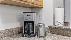 A kitchen with a coffee maker, a kettle, and a paper towel holder on the counter. - Convenient Modern COZY 4BA/2BR Hidden GEM (Milpitas)
