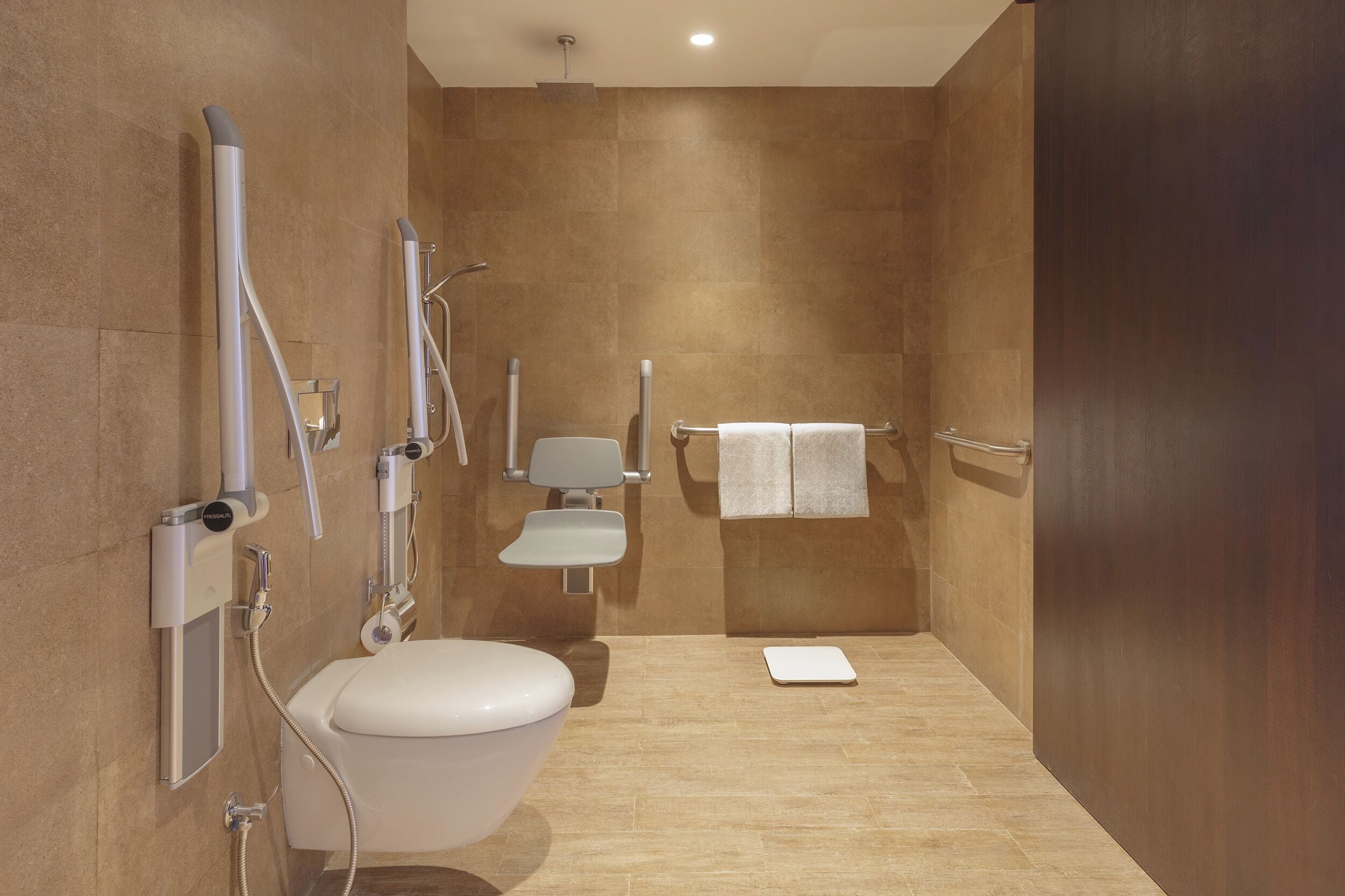 A modern bathroom with a toilet, bidet, and shower.
