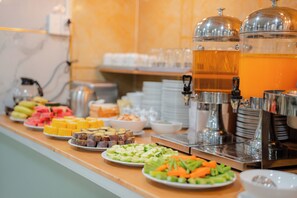 A buffet with various food items and a beverage station. - Duc Minh Saigon Airport Hotel (Ho Chi Minh City)